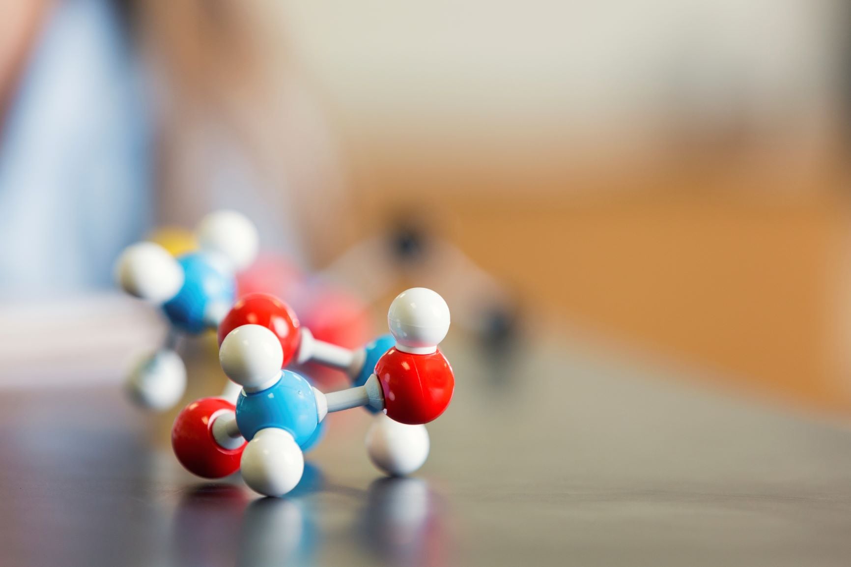Molecular models with red, white, and blue spheres connected by rods.